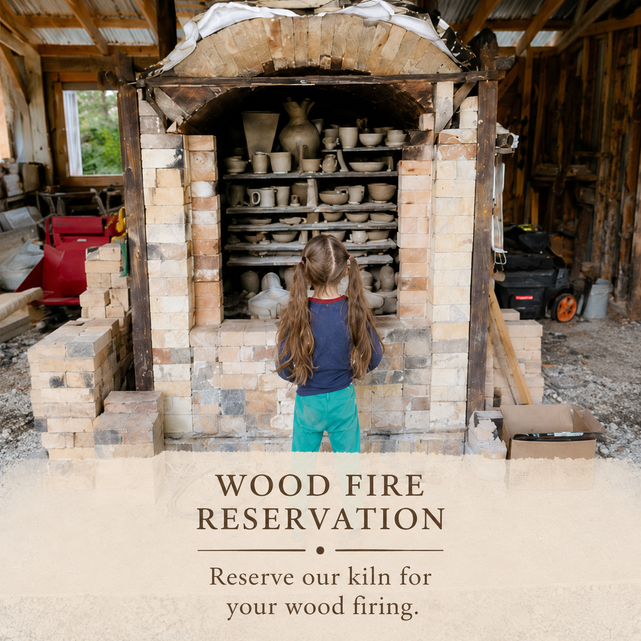 Rustic wood fire pottery kiln filled with handmade ceramics in a bright artisan studio setting, with a child standing nearby in a warm community-focused pottery environment.